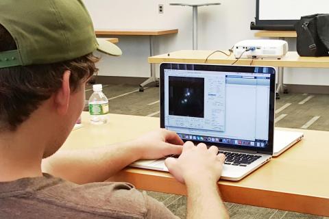 After sample prepping and imaging, a student analyzes data and tracks single particles using MATLAB.