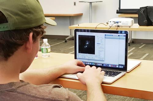 After sample prepping and imaging, a student analyzes data and tracks single particles using MATLAB.